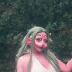 Website Performance - A woman in a green dress with long hair and a green hat