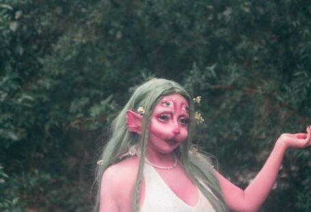 Website Performance - A woman in a green dress with long hair and a green hat