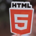 Schema Markup - Man Holding a Paper Cutout with the HTML5 Logo