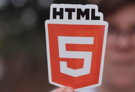Schema Markup - Man Holding a Paper Cutout with the HTML5 Logo