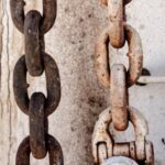 Link Building - Weathered rusty chain on metal fence