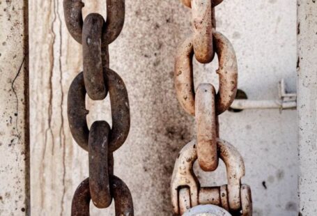 Link Building - Weathered rusty chain on metal fence