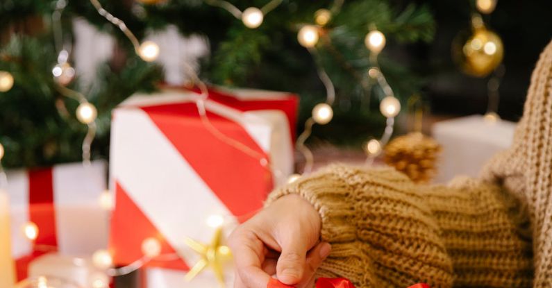 Hosting Package - Woman packaging Christmas present in box