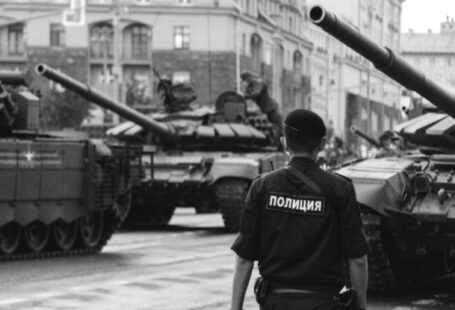 Security Risks - Policeman walking near Tanks
