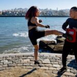Call-to-Action - Young Asian Woman Kicking Instructor MMA Lesson