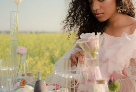 A/B Testing - Young Woman in Airy Summer Dress Creating Perfumes in Flower Field Laboratory