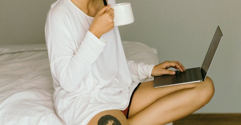 Website Content - Happy woman using laptop and drinking coffee on bed